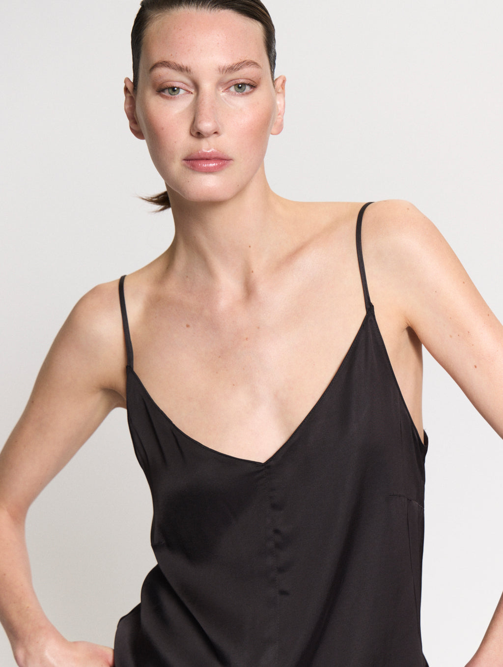 Detail of model wearing the satin Camisole in black