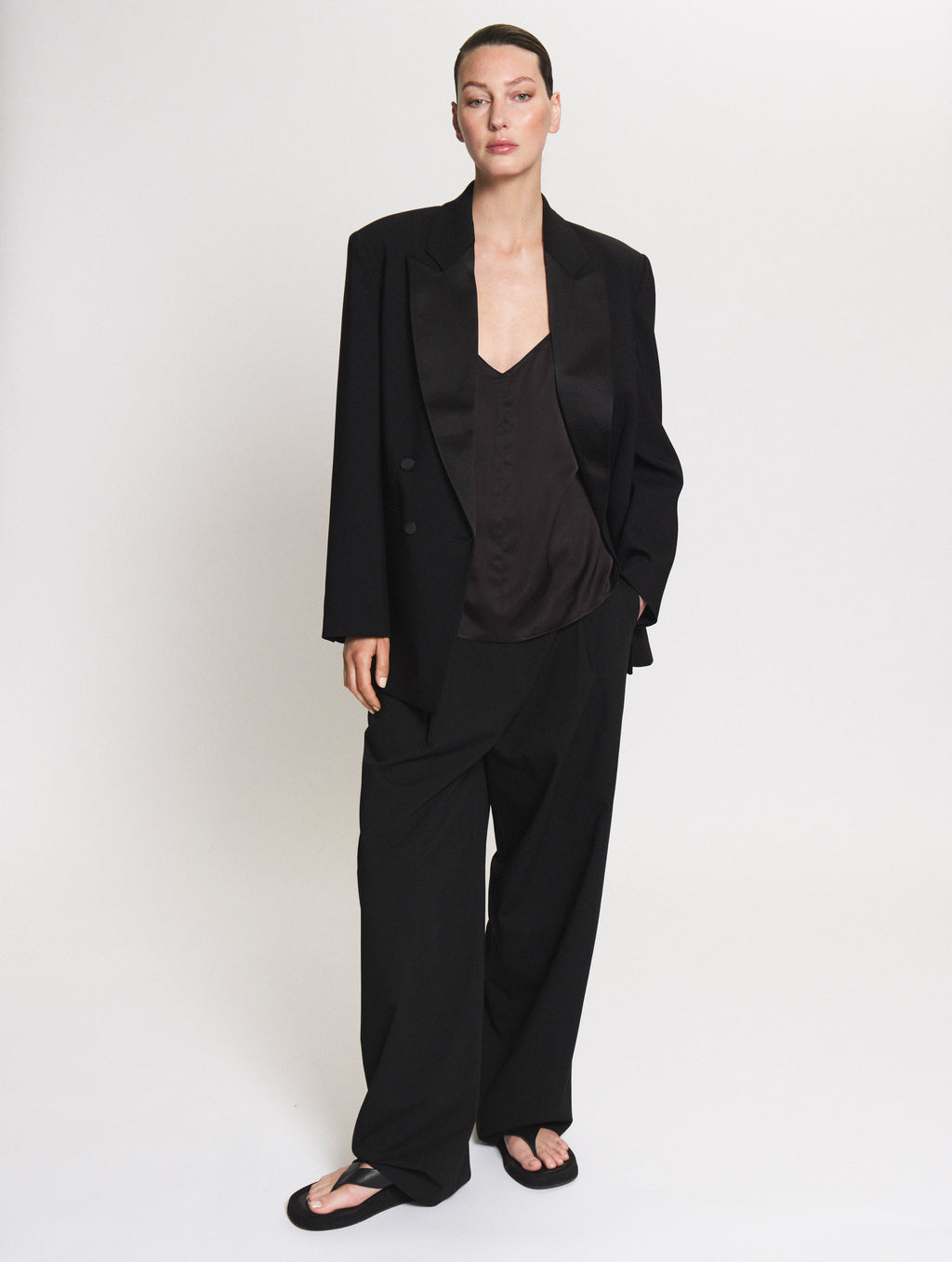 Model wearing the Smoking blazer together with the satin set in black