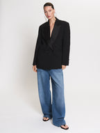 Model wearing a Smoking blazer in black and the Utility in Denim