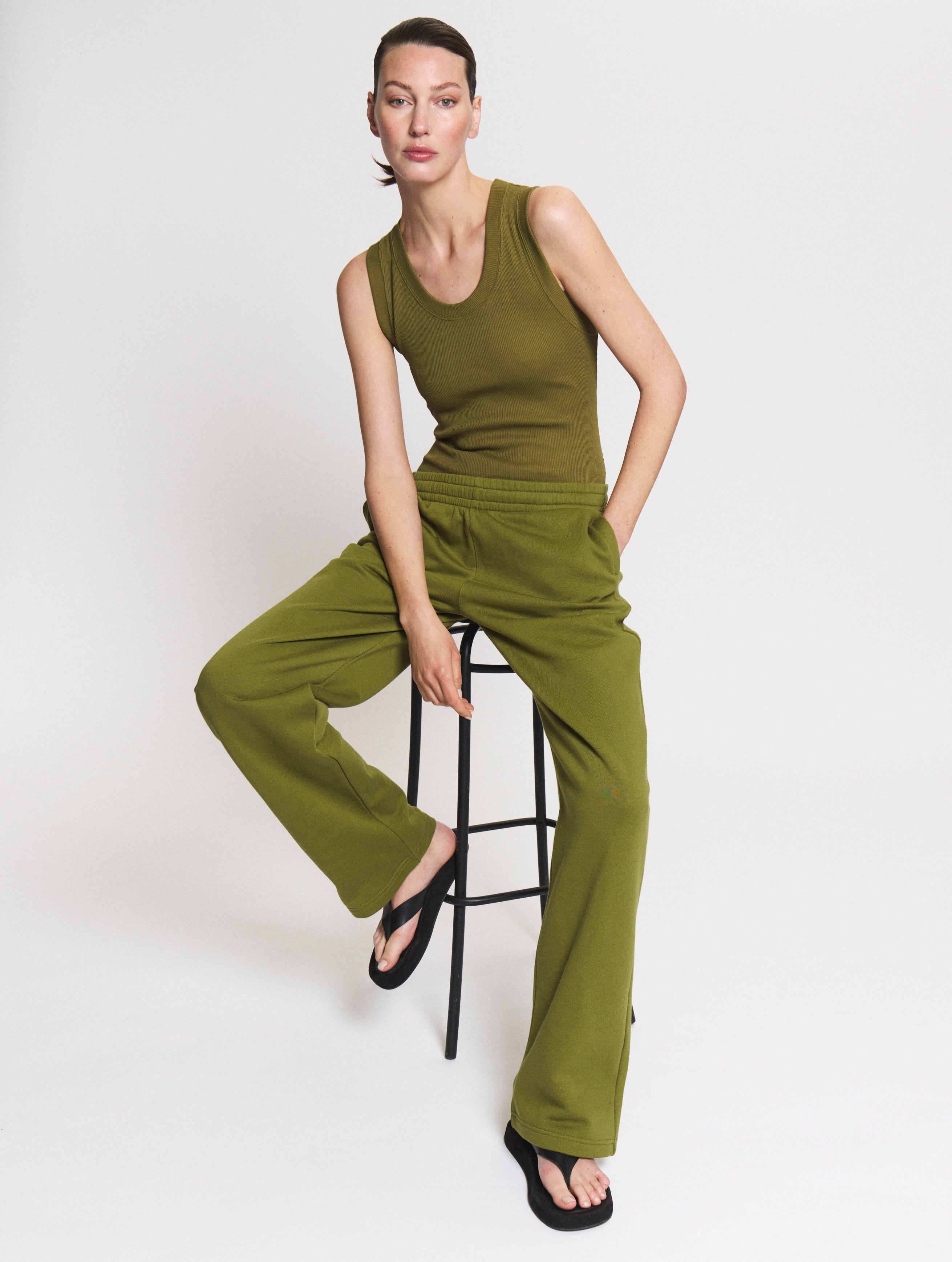 Model wearing the Tanktop body in Olive and the Jogger in Pear