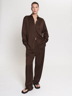 Model wearing the satin set in brown