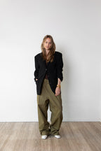 Model wearing the Original blazer in black and the Utility pants in Olive