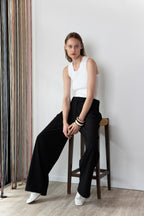 Model wearing the Tanktop body in white and the Pleated pants in black