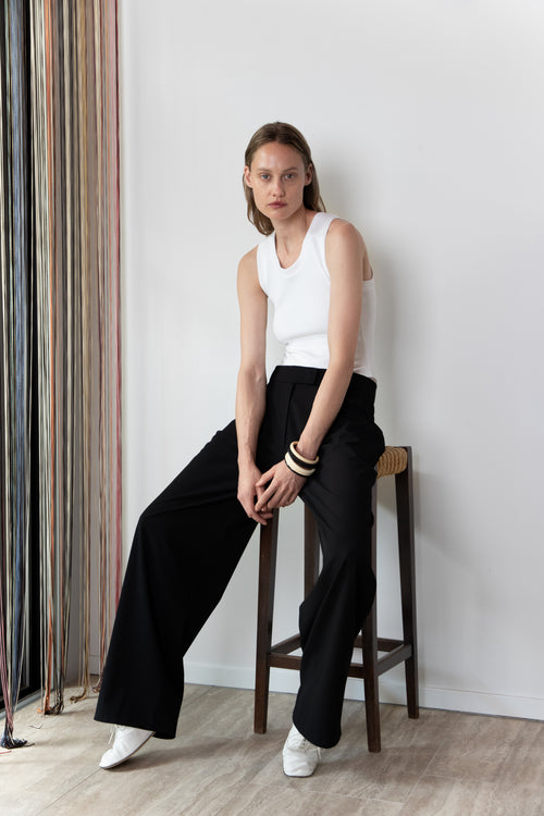 Model wearing the Tanktop body in white and the Pleated pants in black