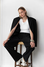 Model wearing the Tanktop body in white and the Pleated pants in black together with the original Blazer in black 
