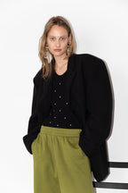 Model wearing The Love Stories x DYO Rhinestones tanktop body in black.  combined with The Blazer and Jogger in pear. 