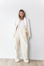Total look of model wearing The Love Stories x DYO Rhinestones tanktop body in white  combined with The Blazer in Off White and The Utility pants