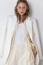Model wearing The Love Stories x DYO Rhinestones tanktop body in white  combined with The Blazer in Off White and The Utility pants