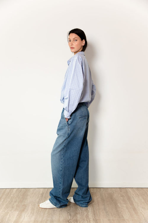 Side view of model wearing the Utility in Denim
