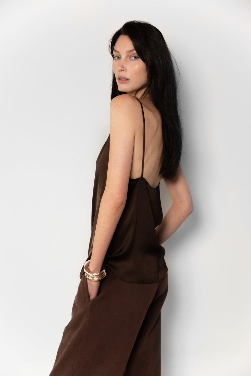 Side view of model wearing the satin Camisole in brown 